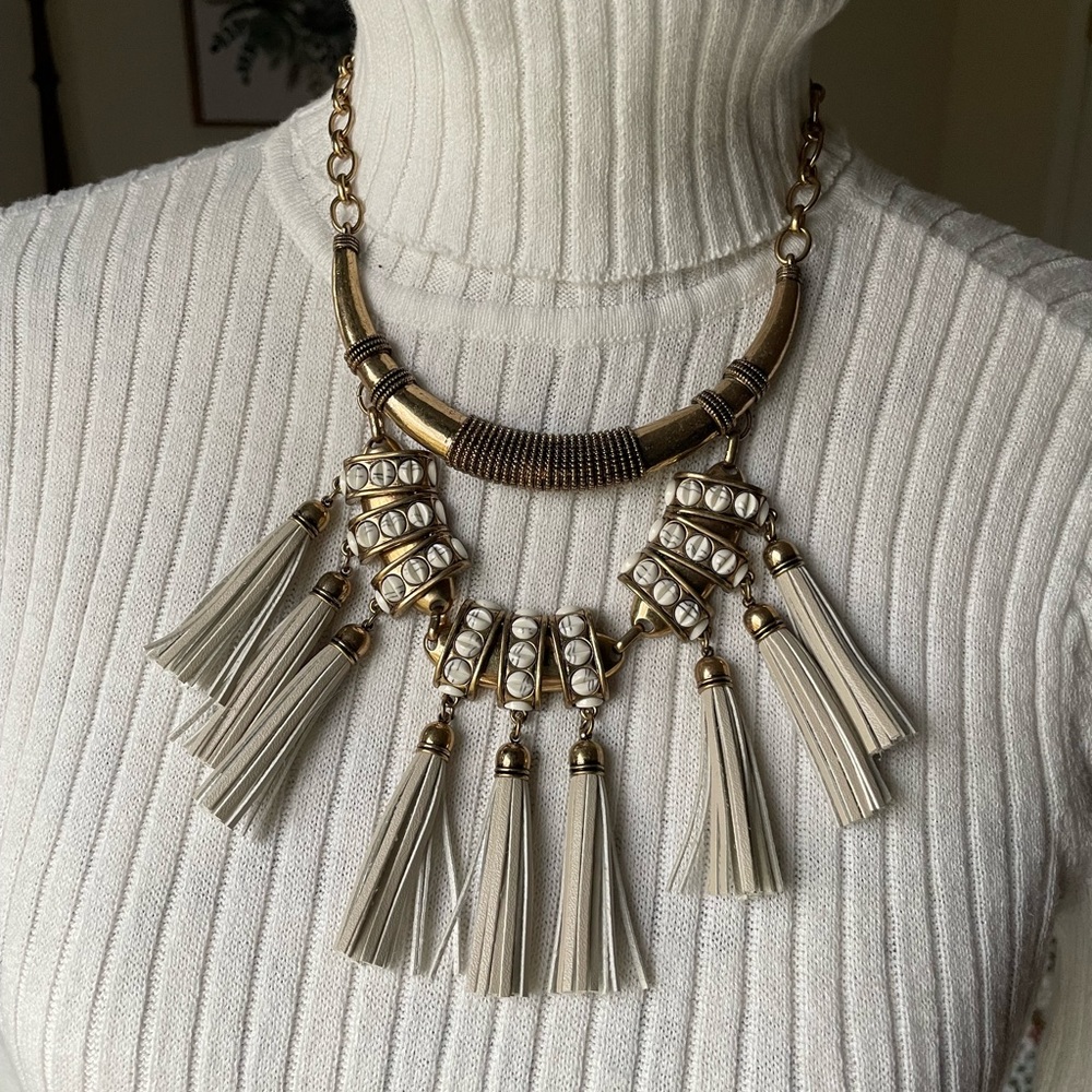 Brass tone statement necklace with leather tassels